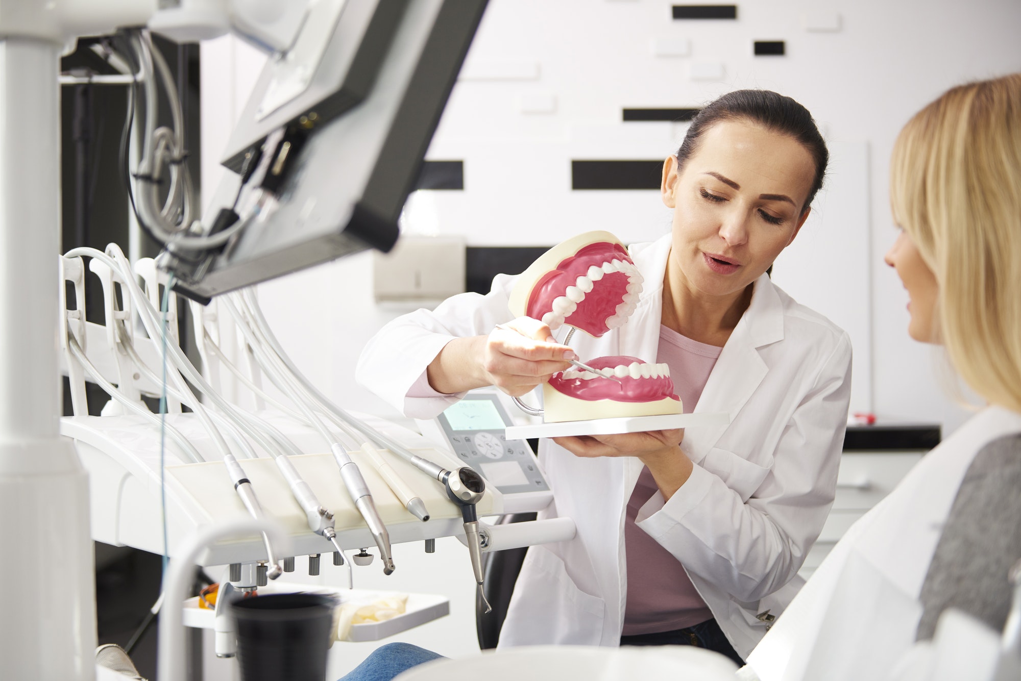 Young dentist and woman having a conversation in dentist's clinic